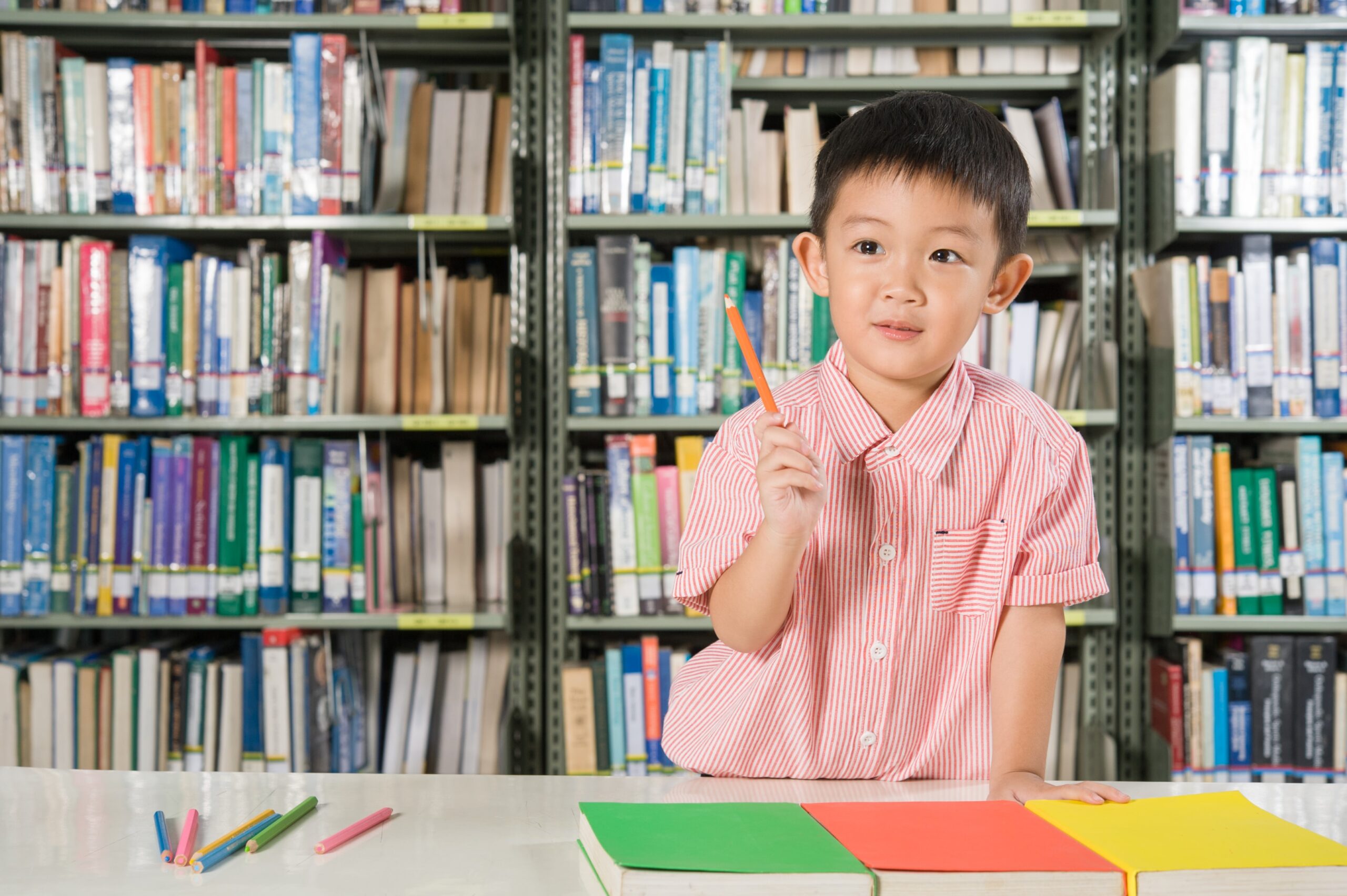 Male student holding a pencil