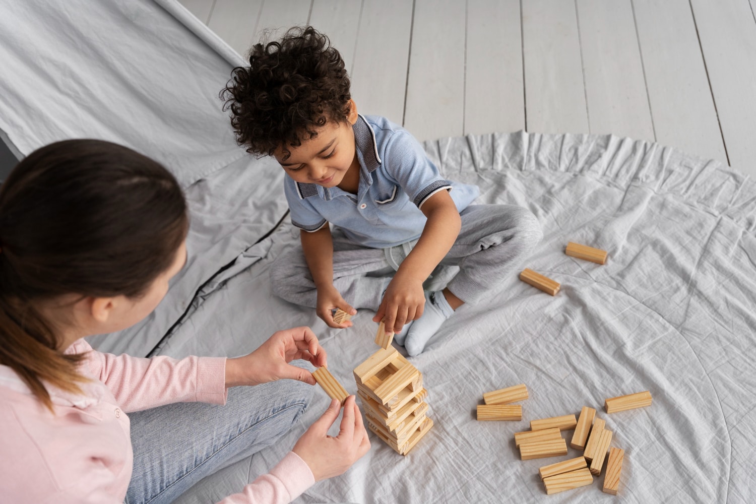 Mother and child stacking up blocks